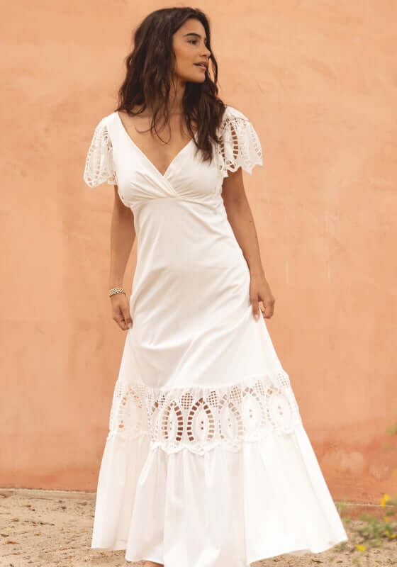 Copacabana Dress White by Sole Lisboa, featuring eyelet cutouts and a flattering V-neckline, perfect for warm beach days.