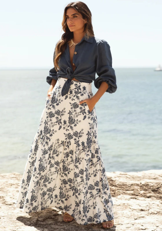 Emma Skirt Azure Bloom by Sole Lisboa, a maxi skirt with a peplum bottom and floral print, perfect for summer days.