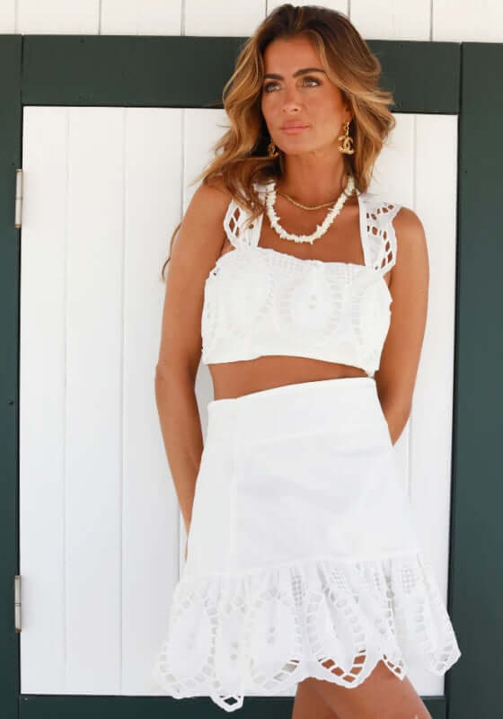 Ibiza Skirt White by Sole Lisboa, showcasing a model in a white skirt with cutout detailing and beachwear elegance.