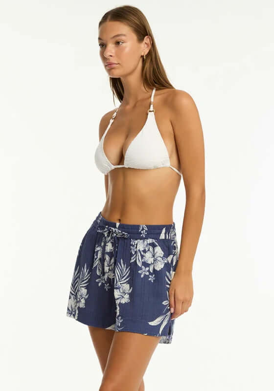 Aloha Beach Short French Navy by Sea Level, model wearing floral tropical print shorts with side pockets.