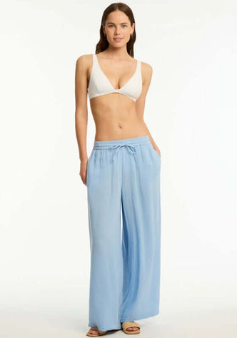 Sunset Beach Pant Cornflower Blue by Sea Level worn with a bikini, featuring wide legs and drawstring waist for comfort.