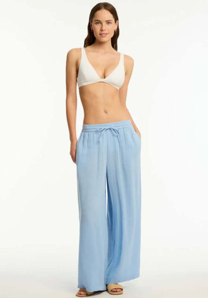 Sunset Beach Pant Cornflower Blue by Sea Level worn with a bikini, featuring wide legs and drawstring waist for comfort.