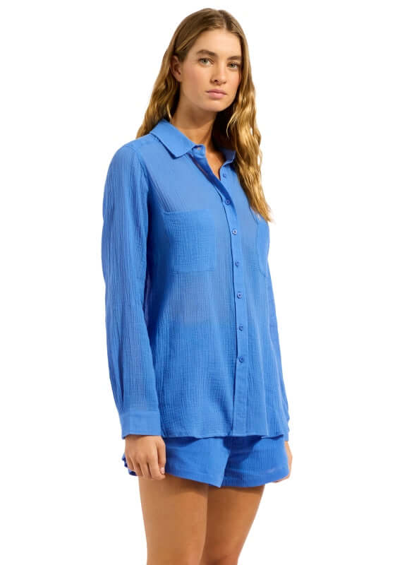 Sapphire Breeze Beach Shirt by Seafolly, vibrant blue long-sleeve shirt worn by a model, perfect for sunny beach days.