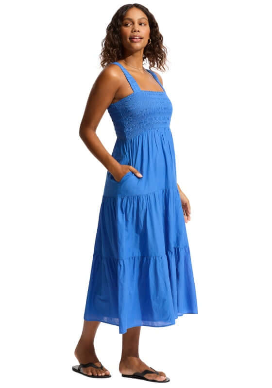 Faithful Midi Dress Sapphire by Seafolly, a woman wearing a blue tiered dress with smocked top and pockets.