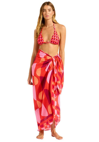 Sorrento Flame Sarong by Seafolly worn by a model, featuring geometric patterns in warm flame tones.