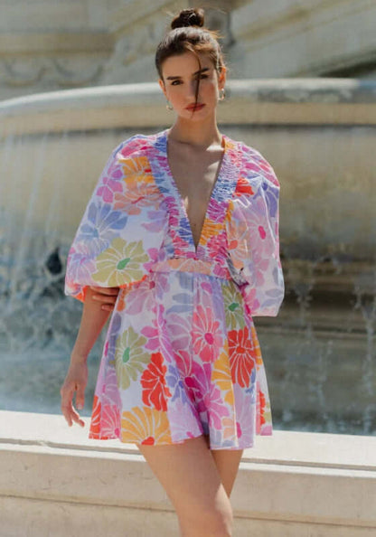 Alicia Jumpsuit Saleya Pastel by Sundress featuring kimono sleeves and V neckline in vibrant floral design.
