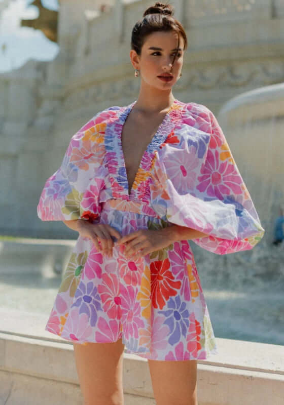 Alicia Jumpsuit Saleya Pastel by Sundress, featuring kimono sleeves, V neckline, gathered waist, and floral patterns.