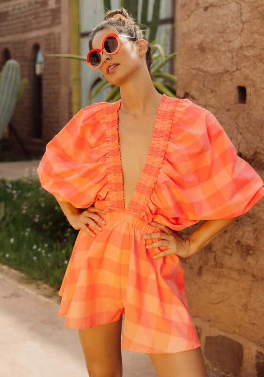 Alicia Jumpsuit Gingham Orange by Sundress, featuring kimono sleeves and a V neckline in large orange and pink gingham.