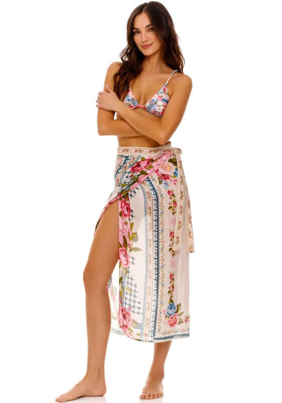 Zinna Pareo Meraki by Agua Bendita, vibrant floral cover-up worn as a skirt over swimwear.