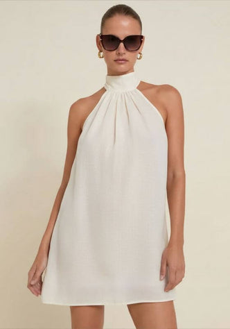 Ivory Ibiza Dress by Away That Day, model wearing a breezy short dress with a high neckline and sunglasses.