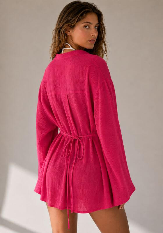 Raspberry La Digue Tunic by Away That Day, featuring a loose silhouette and flowing long sleeves in vibrant pink.