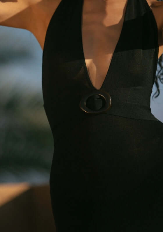 Mozambique Dress Black by Away That Day featuring a plunging neckline and black tortoise shell belt.
