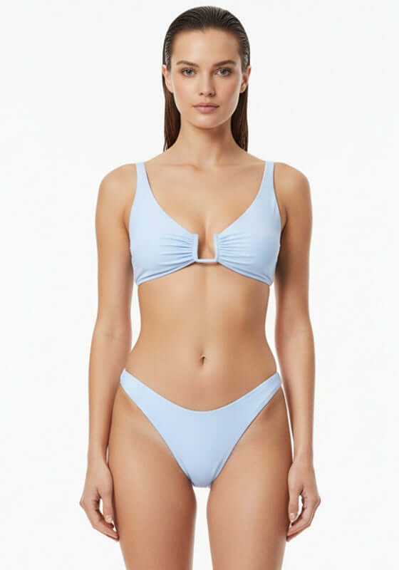 Palma Bikini Top Blue Mist by Away That Day, featuring a sleek light blue design worn by a model.