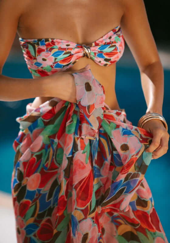 Santorini Sarong Retro Bloom by AwayThatDay, model showcasing colorful floral pattern sarong by the pool.