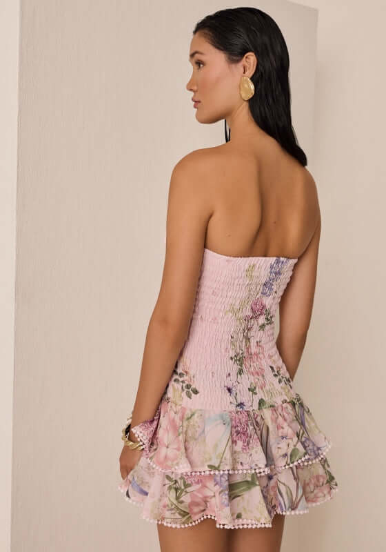 Cusia Short Dress Pink Botanic by Charo Ruiz, showing smocked bodice and frilly layered skirt from the back.