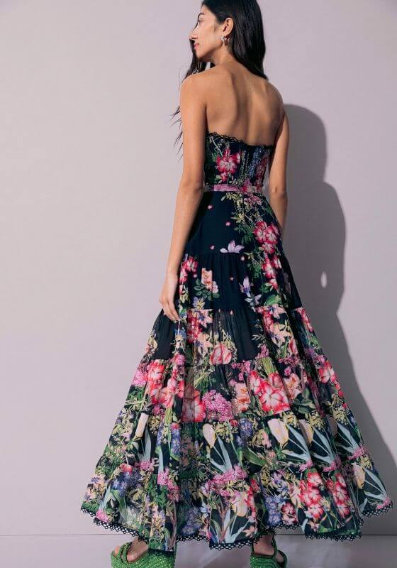 Danny Long Dress Black Botanical by Charo Ruiz, showcasing a floral design with a fitted bodice and flowing skirt.