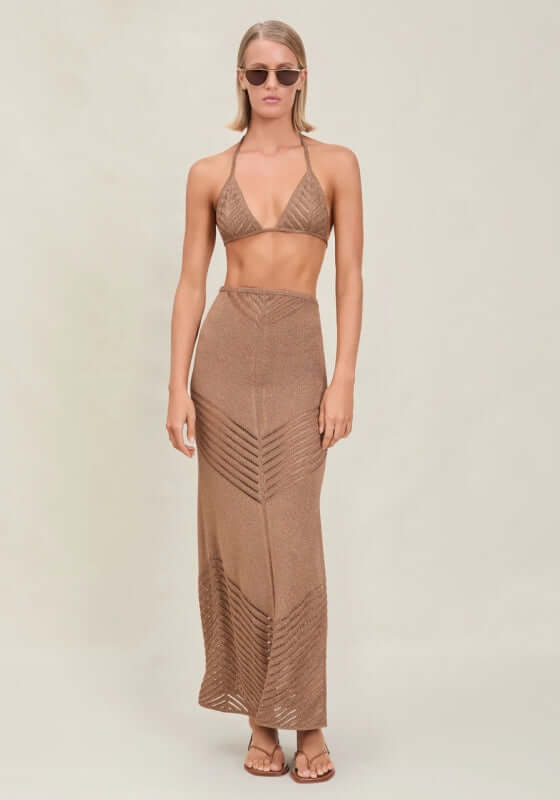 Bria Skirt Truffle by Devon Windsor, showcasing a model in a fine knit maxi skirt with shimmery finish and ladder line details.