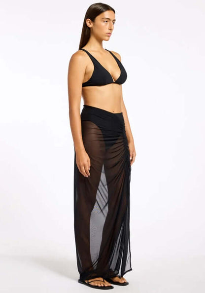 Jetset Lure Mesh Skirt by Jets Swimwear, featuring a sheer black maxi skirt with side ruching for elegant movement.