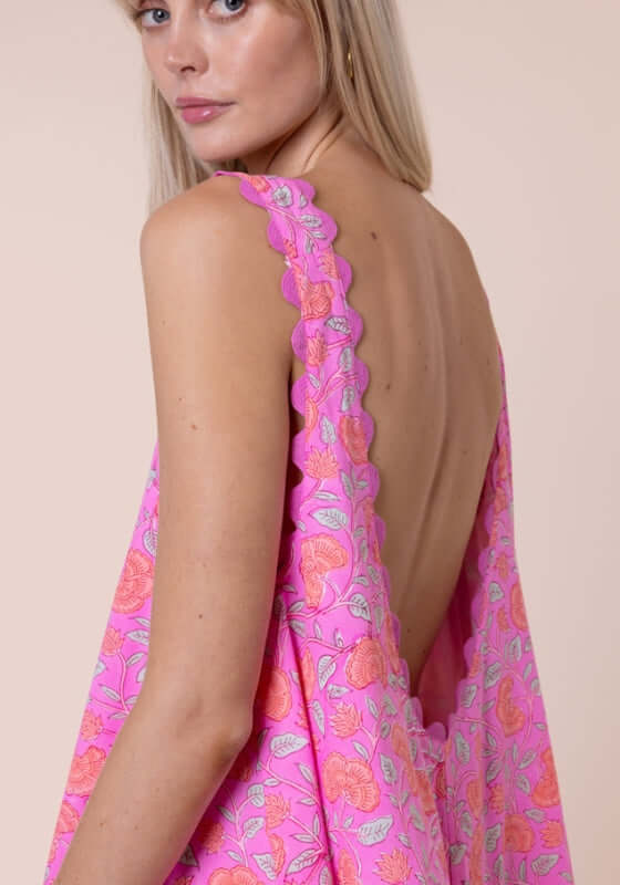 Floral Low Back Dress Fuchsia by Juliet Dunn, showcasing the low back and scalloped hem in vibrant pink floral print.
