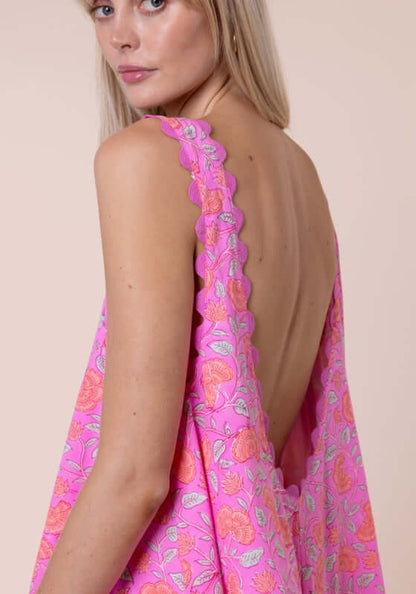 Floral Low Back Dress Fuchsia by Juliet Dunn, showcasing the low back and scalloped hem in vibrant pink floral print.