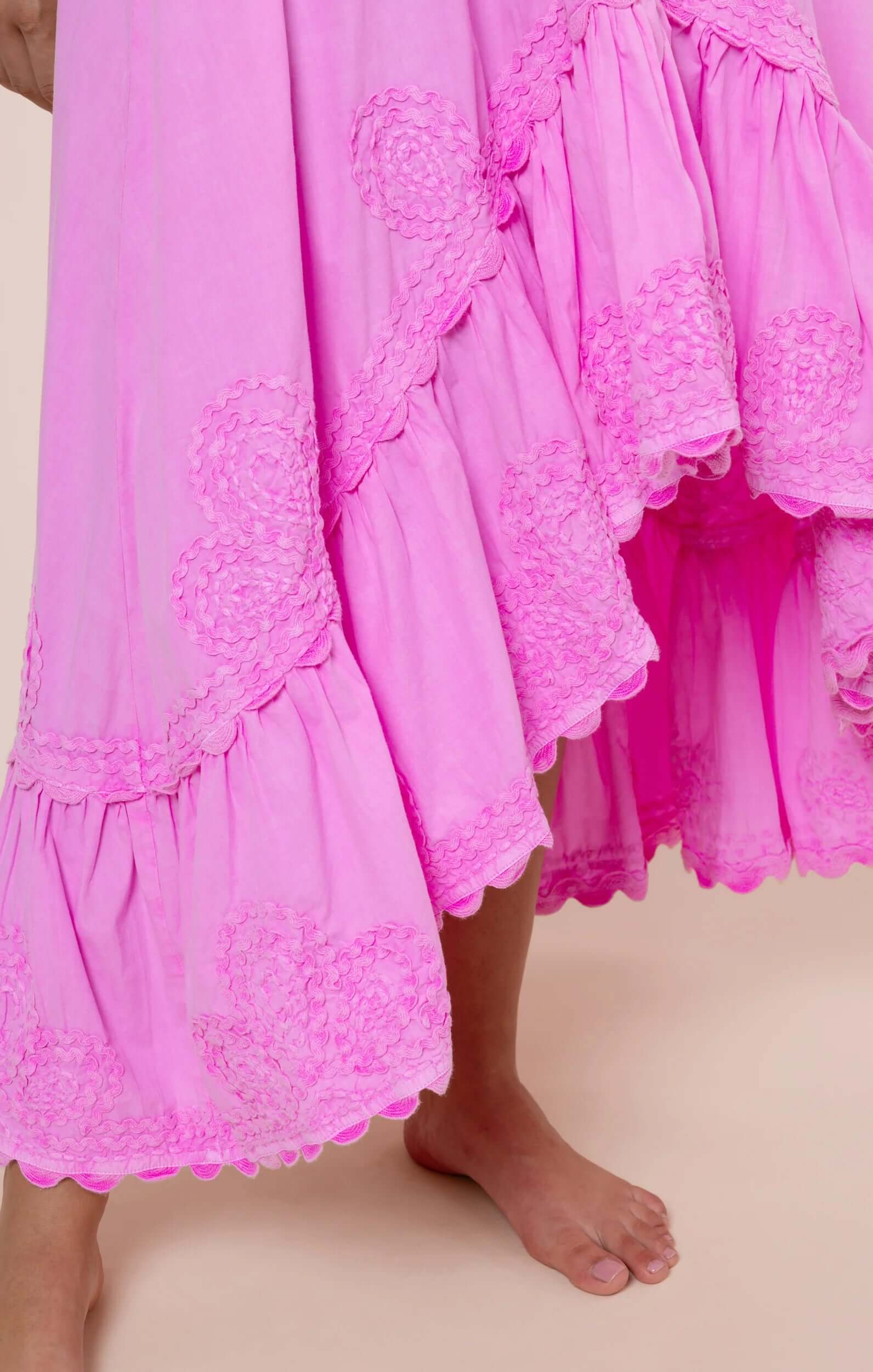 Poplin Hi-Low Dress Hibiscus by Juliet Dunn showing a detailed scalloped hem and vibrant pink fabric.
