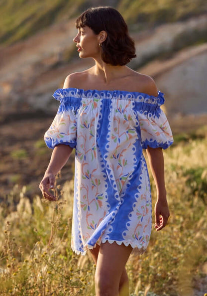 Birds Of Paradise Off Shoulder Dress by Juliet Dunn, showcasing a woman in a colorful off-shoulder dress with floral patterns.