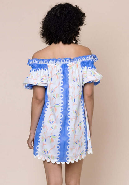 Birds Of Paradise Off Shoulder Dress by Juliet Dunn, showcasing the back view with vibrant blue patterns and puff sleeves.