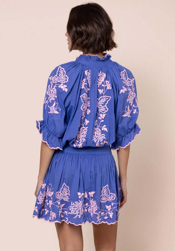 Butterfly Blouson Dress Denim by Juliet Dunn, showcasing a back view with pink butterfly embroidery on denim blue.