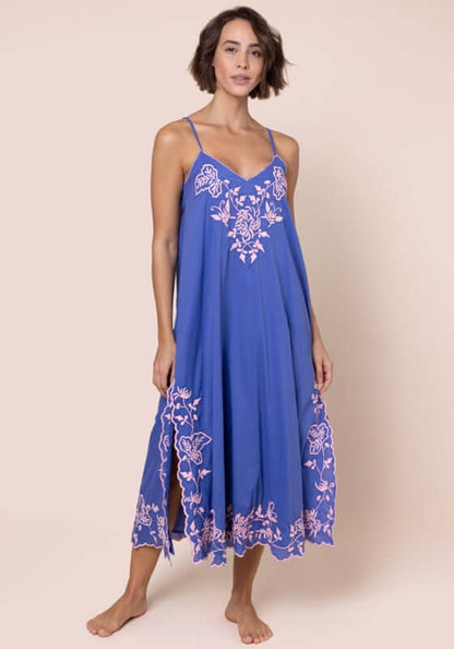 Butterfly Slip Dress Denim Candy by Juliet Dunn, showcasing a woman in a flowing blue dress with pink butterfly embroidery.