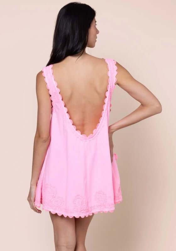 Ric Rac Low Back Dress Flamingo by Juliet Dunn, showing the back view of a pink low back mini dress with scalloped edges.
