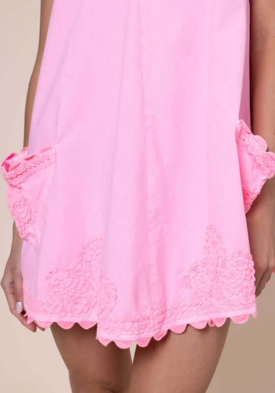 Ric Rac Low Back Dress Flamingo by Juliet Dunn, showing pink dress with playful patch pockets and scalloped hem.