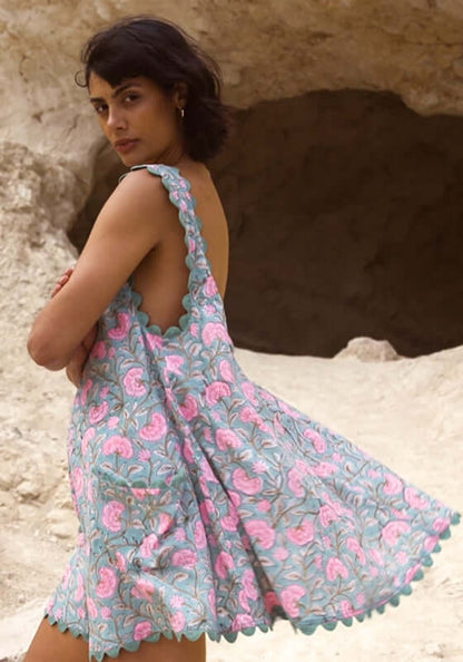 Gingko Low Back Dress Cactus by Juliet Dunn, featuring a model showcasing its scalloped hem in a vibrant floral print.