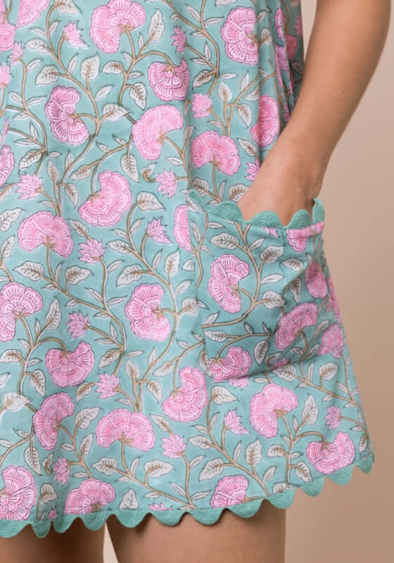 Gingko Low Back Dress Cactus by Juliet Dunn, featuring a vibrant floral print and scalloped hem with pockets.