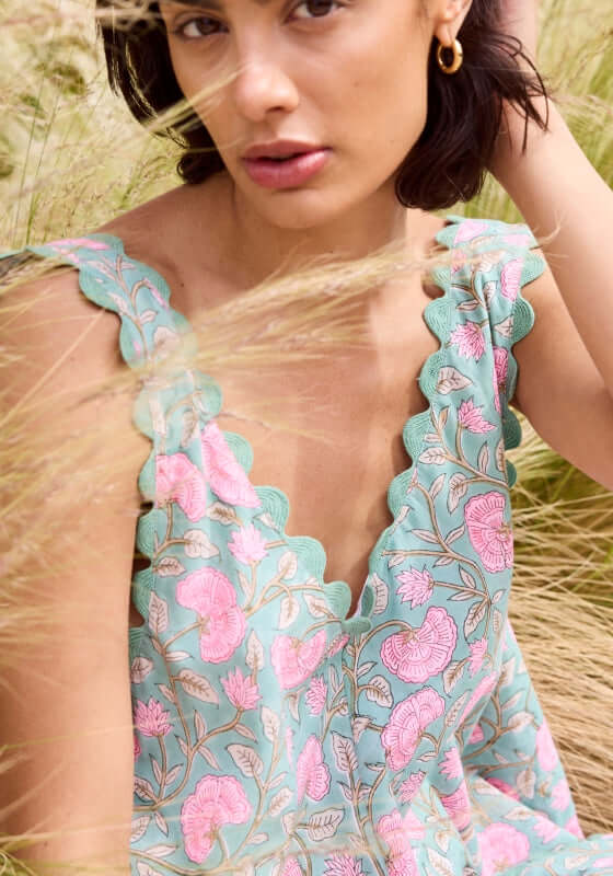 Gingko Low Back Dress Cactus by Juliet Dunn, featuring a floral print and scalloped hem in a summer setting.