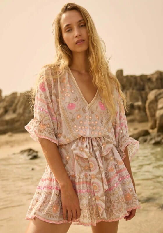 Mexican Embroidered Mini Beach Dress by Juliet Dunn featuring pink embroidery and a breezy silhouette on a beach.