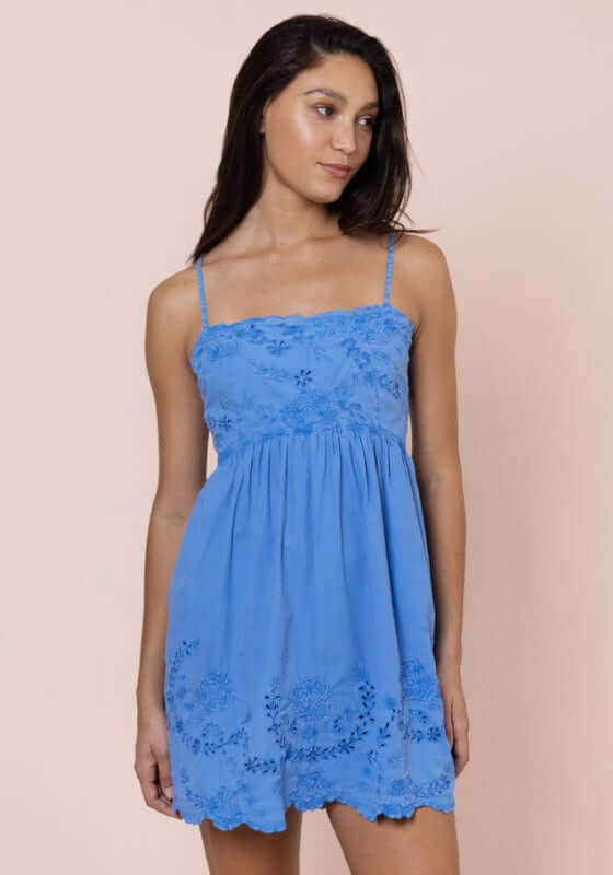 Poplin Tie Back Dress Ocean Blue by Juliet Dunn, showing a model wearing a charming mini dress with tie back and spaghetti straps.