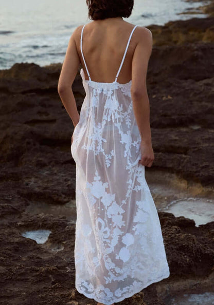 Embroidered Net Maxi Dress by Juliet Dunn, showcasing delicate floral embroidery and adjustable straps on a rocky beach.