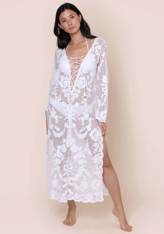 Embroidered Net Lace Up Kaftan by Juliet Dunn, model wearing a white lace-up kaftan with side split and floral embroidery.