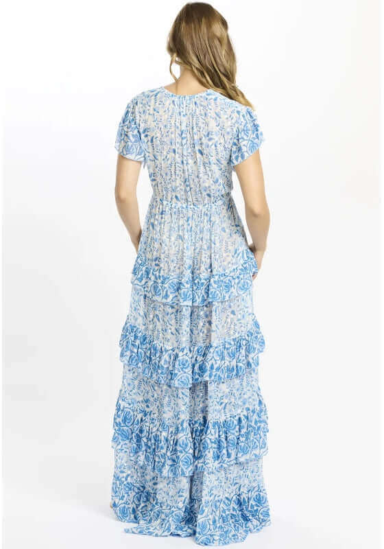 Celia Dress Blue by Miss June, showcasing the back of a tiered maxi dress with blue and white floral patterns.