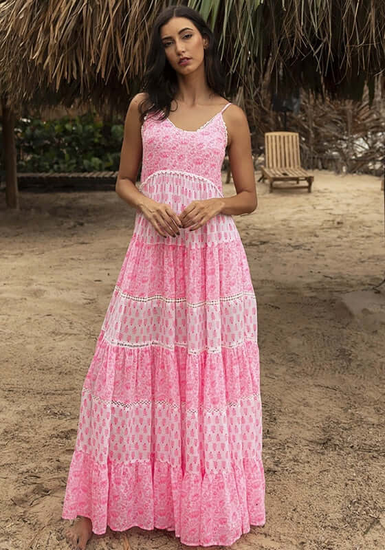 Davana Dress by Miss June, a vibrant neon pink tiered maxi dress with spaghetti straps and lace cut out trim.