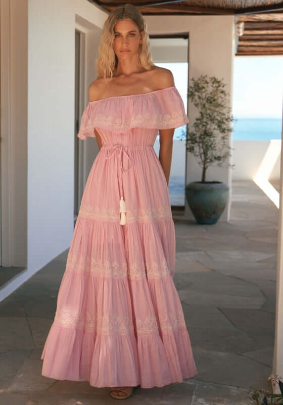 Malone Dress Pink by Miss June, featuring off-shoulder neckline, tiered silhouette, and white embroidery.