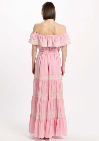 Malone Dress Pink by Miss June, showcasing the elegant off-shoulder back and tiered silhouette with white embroidery.