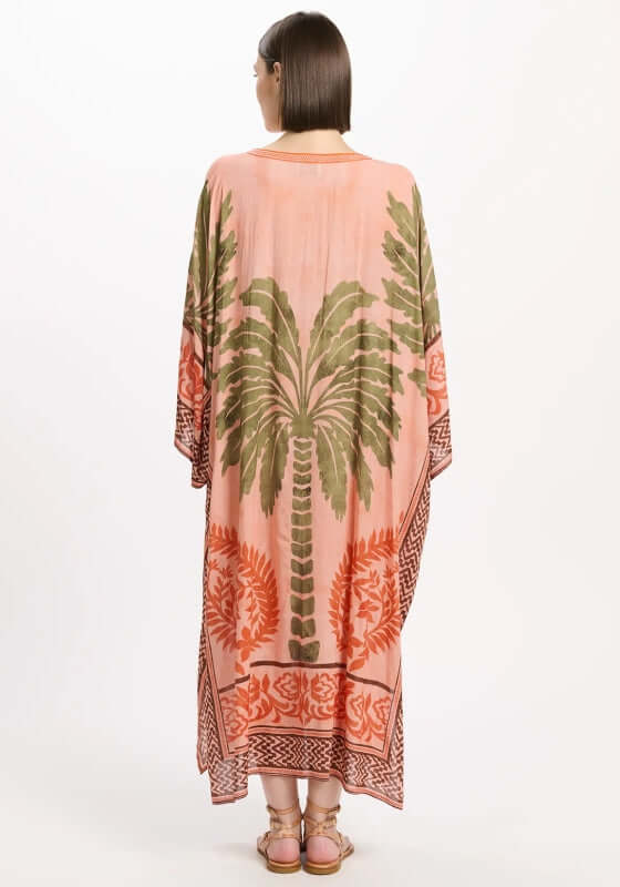 Rhoda Long Kaftan Peach by Miss June featuring a tropical palm print and flowing sleeves, showcased from the back.