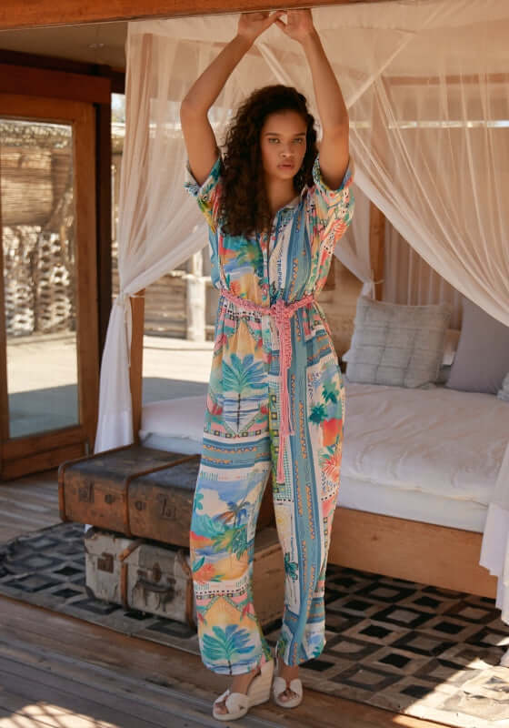 Swan Jumpsuit by Miss June, featuring a colorful pattern and relaxed fit in a beach setting.
