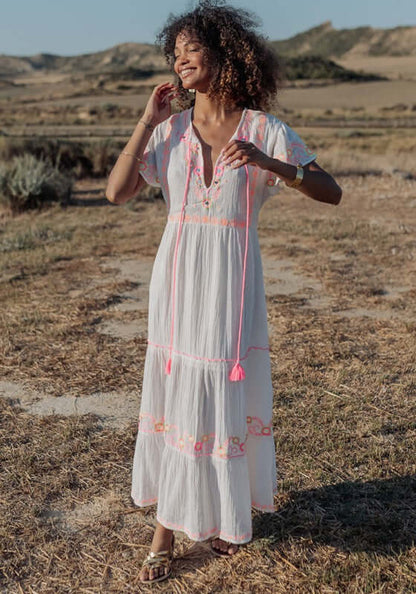 Holbox Long Dress Natural by Piti Cuiti, a flowing beach dress with hand-embroidered details and vibrant tassels.