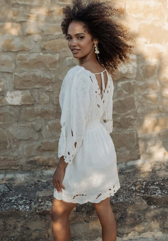 Rodhas Dress White by Piti Cuiti, a breezy white dress with floaty sleeves and delicate cut-out details.