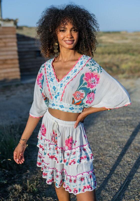 Bonaire Skirt White Pink by Piti Cuiti, featuring a tiered design with vibrant hand-painted pink details.