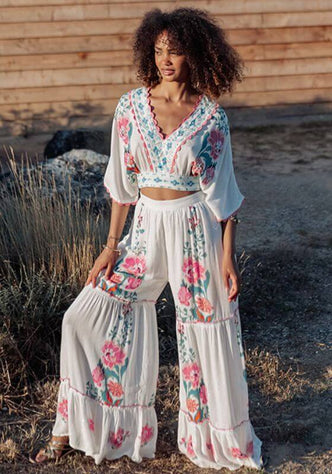 Bonaire Beach Trousers White Pink by Piti Cuiti, featuring a tiered ruffle design and hand-painted floral details.