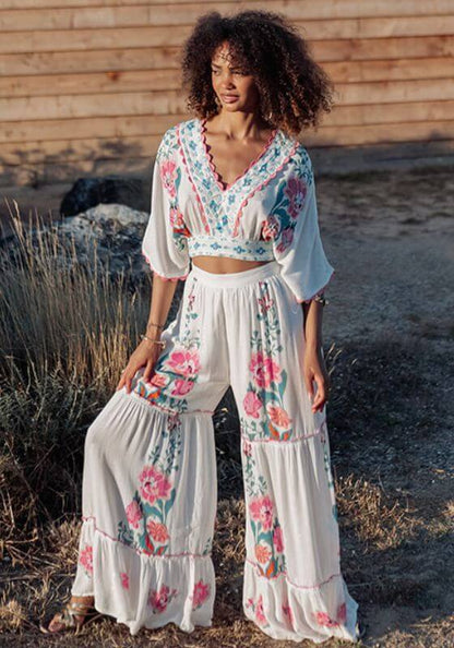 Bonaire Beach Trousers White Pink by Piti Cuiti, featuring a tiered ruffle design and hand-painted floral details.