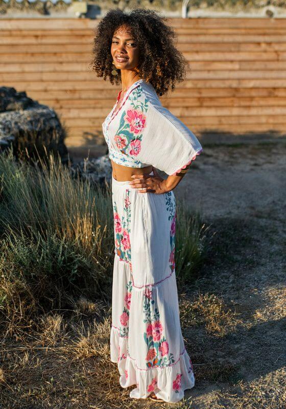Bonaire Beach Trousers White Pink by Piti Cuiti, model wearing a stylish tiered ruffle leg design in soft white fabric.